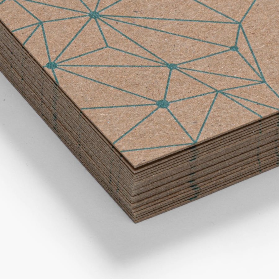 A stack of kraft business cards with a warm, plaid patterning from a rustic campsite company.