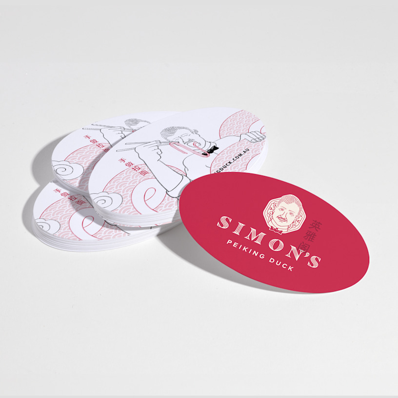 A stack of oval business cards for a restaurant, with front and back views.