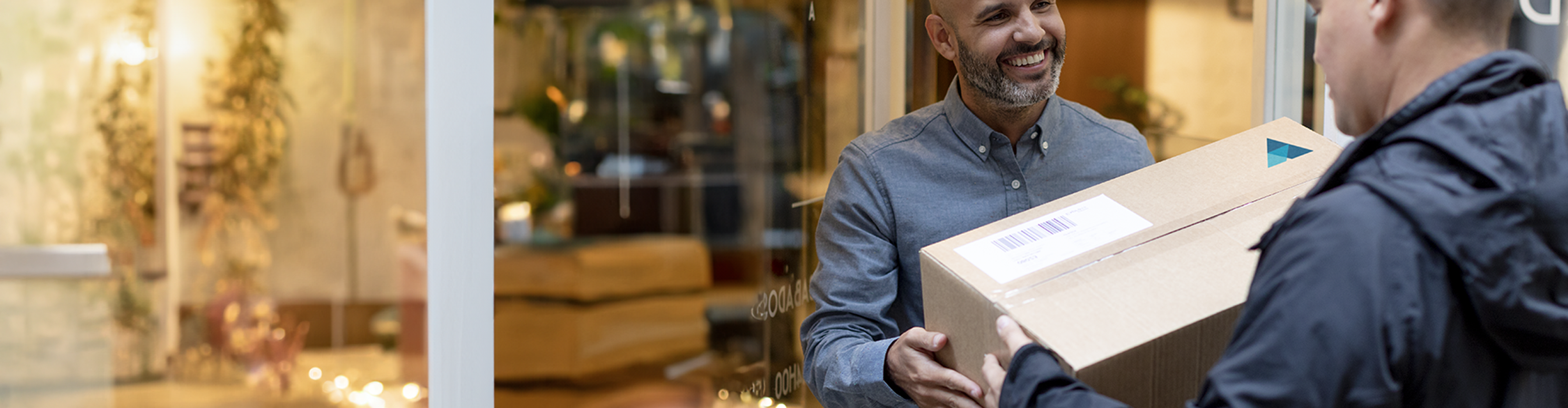 A customer receiving their fast-shipping business cards delivery from VistaPrint. 